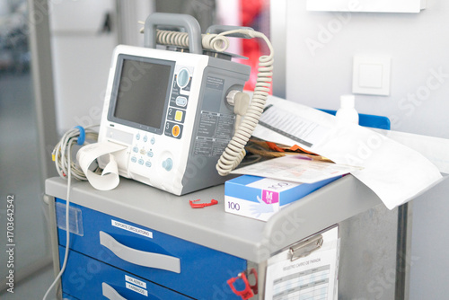 Defibrillator standing on crash cart in hospital room