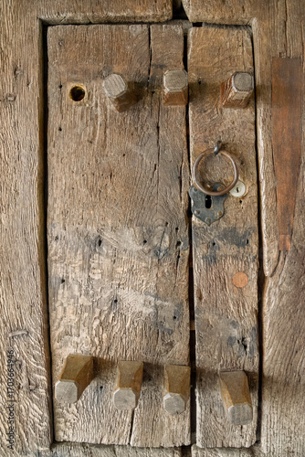 Fotografie Close-up of a small wooden inspection door built into a larger rustic door