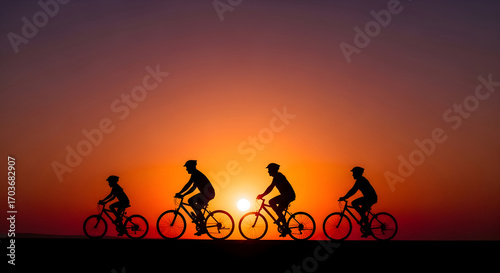 Silhouette of a group cycling against a vibrant sunset creating an inspirational scene showing