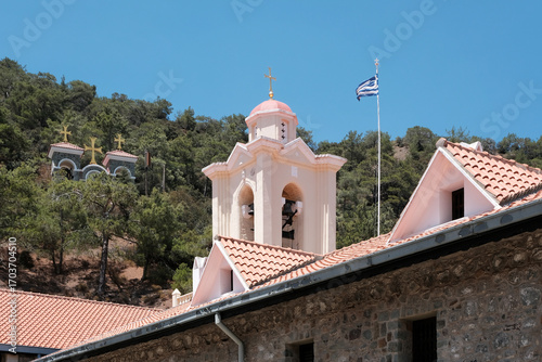 Greek flag above Holy Monastery of the Virgin Mary of Kykkos on sunny day. Cyprus.
