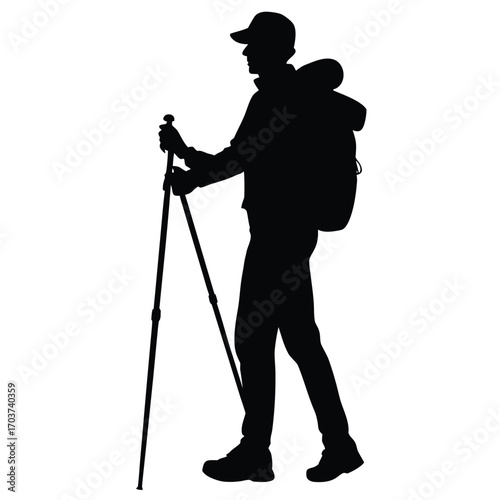 Silhouette of a Hiker with Backpack and Trekking Poles in Nature