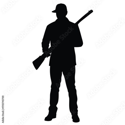 Silhouette of Man Holding Rifle Wearing Cap and Jacket Standing Tall
