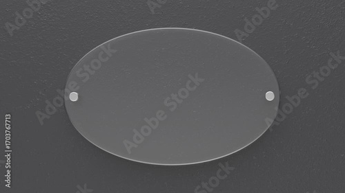 Transparent oval glass nameplate on dark grey wall