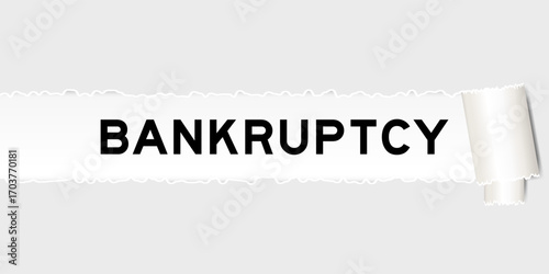Ripped gray paper background that have word bankruptcy under torn part