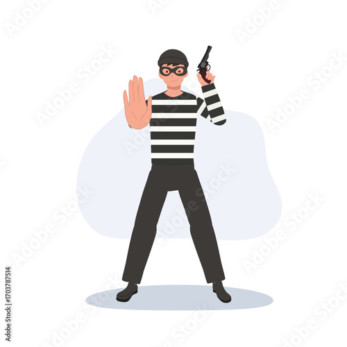 armed burglar standing with weapon and raised hand masked bandit. robbery crime