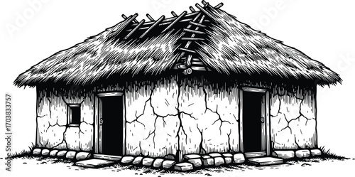 Dilapidated hut with thatched roof, cracked walls, and open doorways
