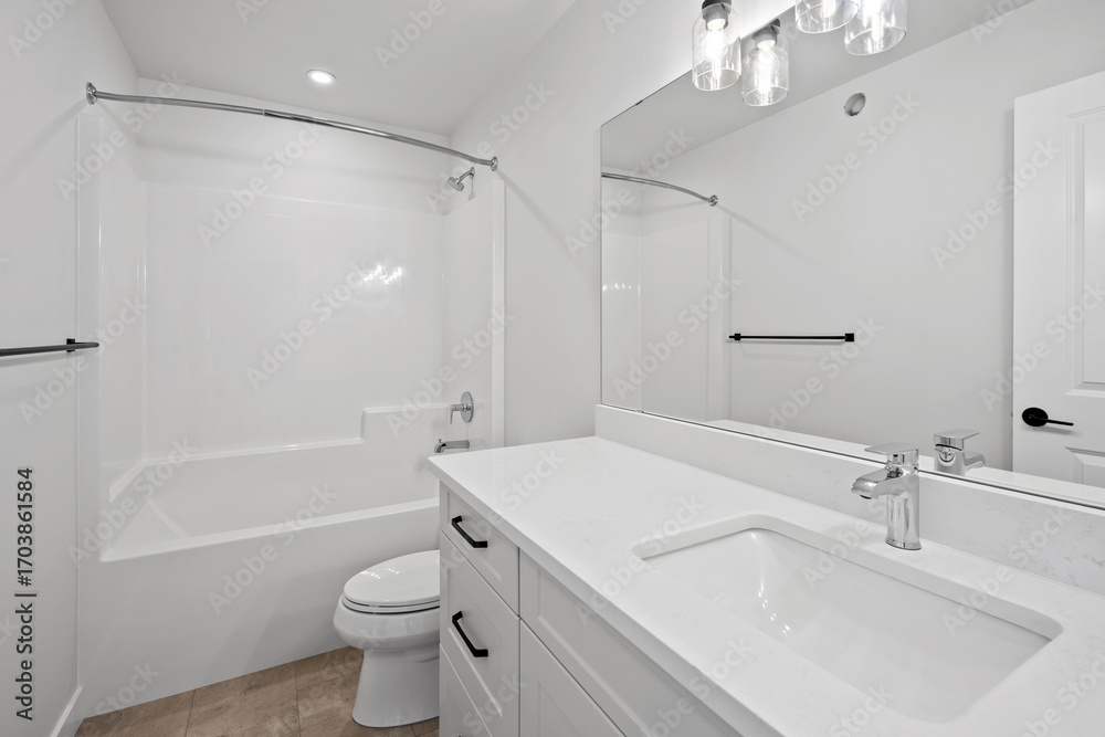 Bathroom with a white toilet, sink, and bathtub Bathroom with a white toilet, sink, and bathtub