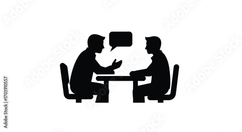 Two people in silhouette talking across a table