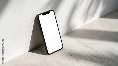 Smartphone Displaying a Blank Screen Against a Textured White Background