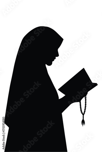 Silhouette of a Muslim woman wearing hijab reading Quran