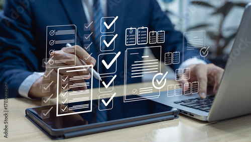 Businessman working on laptop with digital checklist and document approval icons, symbolizing business performance tracking online form completion, survey evaluation, and efficient workflow management