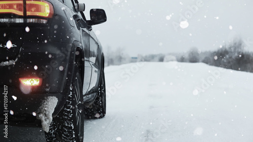 Car in the winter forest. Traveling through a snowy park by car.