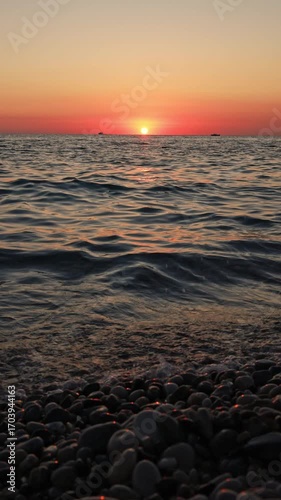 Abstract marine contrasting background with waves and pebbles.