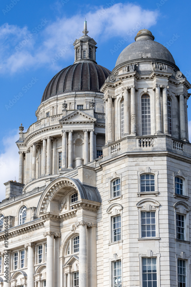 Obraz premium Two Domes on Classical Building Against Blue Sky in Liverpool, UK.