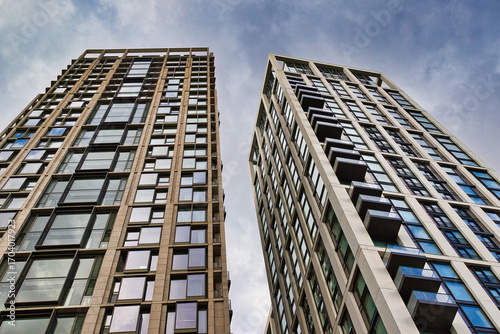 Two modern residential high-rise buildings with balconies  in London, UK.