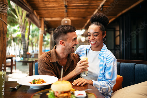 Happy loving couple enjoying breakfast in a cafe. Love, dating, food, lifestyle