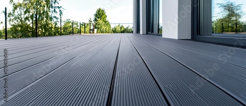 Modern dark gray composite deck and green garden