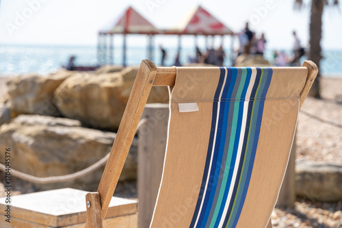 Beach scene with deck chair and distant pier