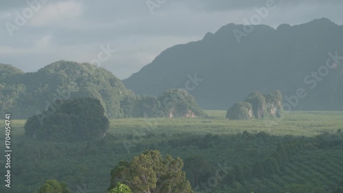 Sunrise view with mist over mountains and forest at Din Daeng Doi, Krabi, Thailand, creating a serene and dramatic natural landscape.