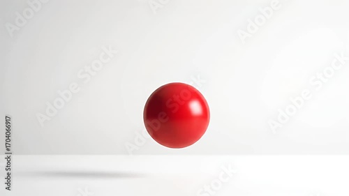 Dynamic vibrant red sphere bouncing in empty white space