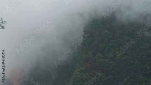Sunrise view with mist over mountains and forest at Din Daeng Doi, Krabi, Thailand, creating a serene and dramatic natural landscape.