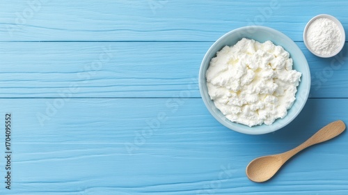 Cottage cheese whey wooden spoon on blue table