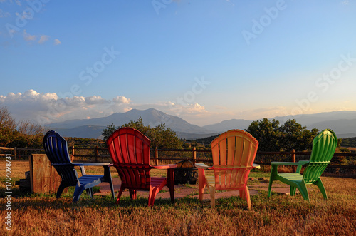Colorful lawn chairs in yard looking at Mount Soris