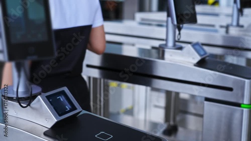 Woman holding mobile phone scanning enters checkpoint, slow motion video