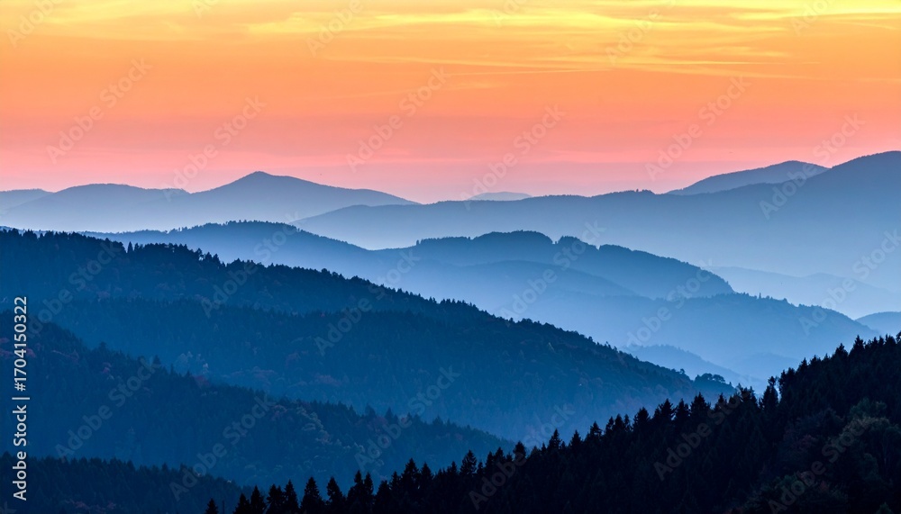Obraz premium Serene Mountain Range at Sunrise with Hazy Blue Layers and Golden Sky.