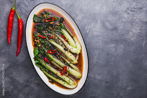 Obraz na plátně fried pak choi cabbage with garlic and soy sauce, Pak Choi or Bok Choy on dark g