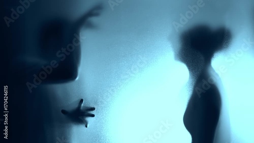 Couple arguing behind the frosted glass