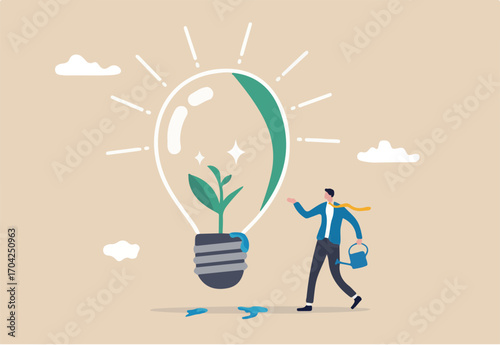 Ecology and sustainable business, green idea or protection against world climate change, environmental care concept, smart businessman watering seedling sprout growing inside green lightbulb idea. 