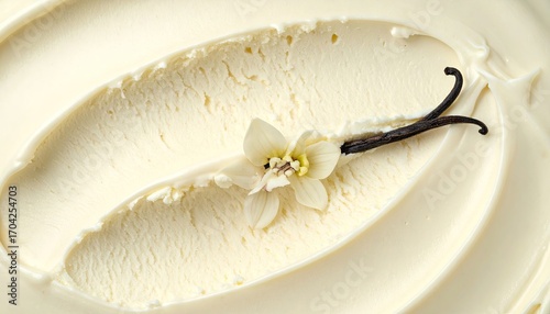 Close-up of creamy vanilla ice cream, with a vanilla bean and small flower