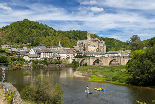 Tourists Kayaking and Paddleboarding near Estaing Castle in Aveyron, France