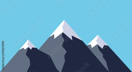 Majestic mountain peaks with snow-capped summits under a clear blue sky.