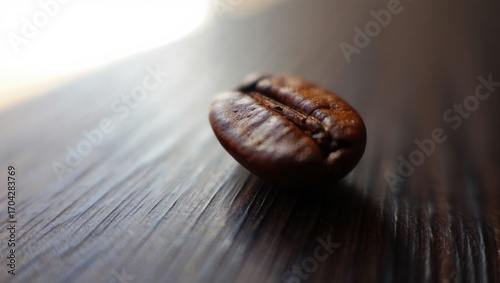 Close-Up of a Single Coffee Bean Resting on a Wooden Surface, Capturing the Rich Color and Texture of the Bean's Exterior