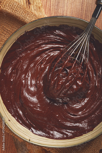 a bowl of chocolate dough, a whisk for whipping, baking, structure and consistency, homemade, top view, no people,