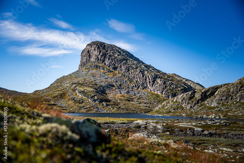 Rugged Norwegian Mountain Landscape in Autumn with a Calm Lake