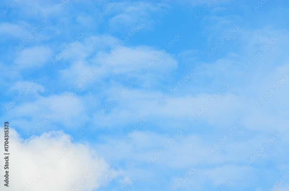 Fototapeta premium Beautiful blue sky with scattered cumulus clouds on sunny day