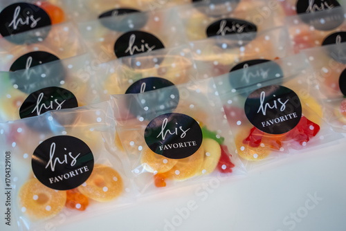 Wedding candy favor bags with gummy candies in polka dot packaging labeled His Favorite.