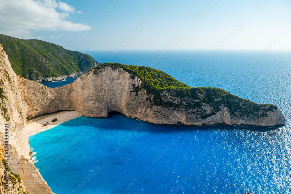 Obraz premium Panorama of Navagio Shipwreck Beach Zakynthos Greece with turquoise blue water white cliffs and sandy cove seen from above top travel destination photo spot