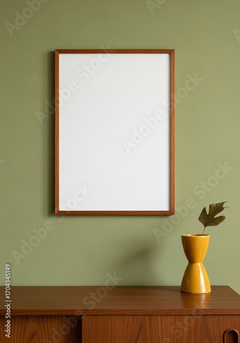Mid Century Modern Interior with a Blank Wooden Frame Mockup on a Green Wall above a Teak Sideboard and Yellow Vase
