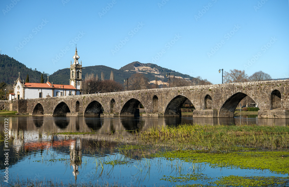 Fototapeta premium Historic Bridge and Church of Santo António da Torre Velha on a Sunny Day in Ponte de Lima, Portugal