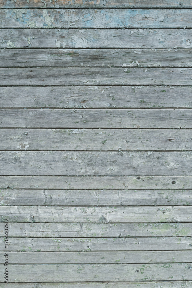 Obraz premium A weathered gray wooden wall with horizontal planks and peeling paint
