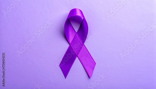 Purple awareness ribbon on a purple surface