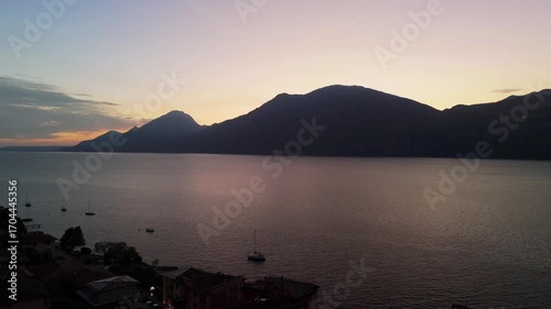 Aerial Sunset Over Lake Garda: Drone Flight from Porto di Brenzone, Brenzone sul Garda, Italy
