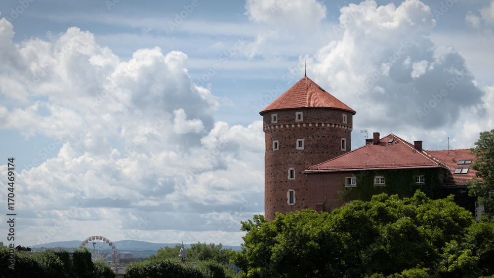 Fototapeta premium Medieval tower of Wawel Castle in Krakow against a cloudy sky