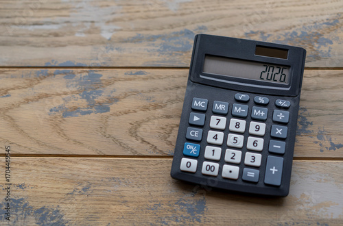 Calculator with the number 2026 on the display. Concept of finance, taxes, savings and economic crisis.