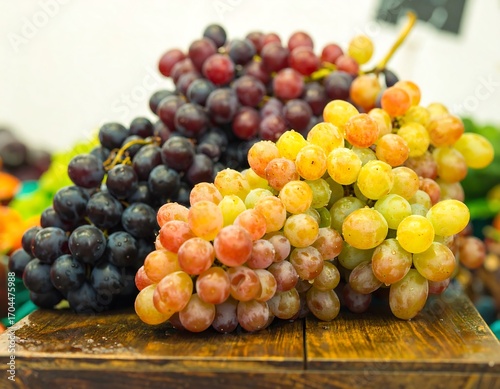 Clusters of colorful grapes on a wooden surface