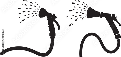 Two garden hose spray nozzles spraying water in silhouette